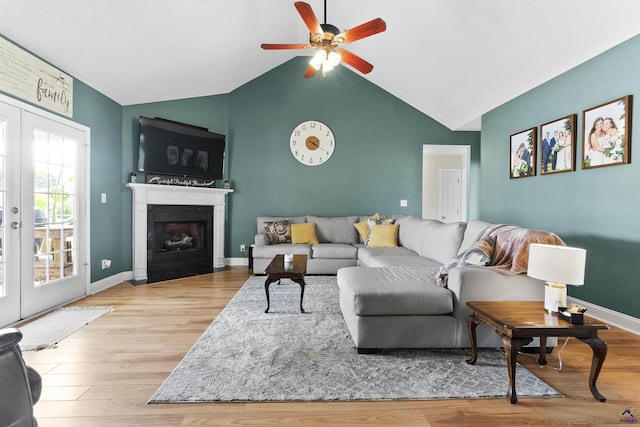 2725 Moseley Rd, Byron, GA 31008 - living room featuring a ceiling fan, wood finished floors, a fireplace with flush hearth, baseboards, and high vaulted ceiling