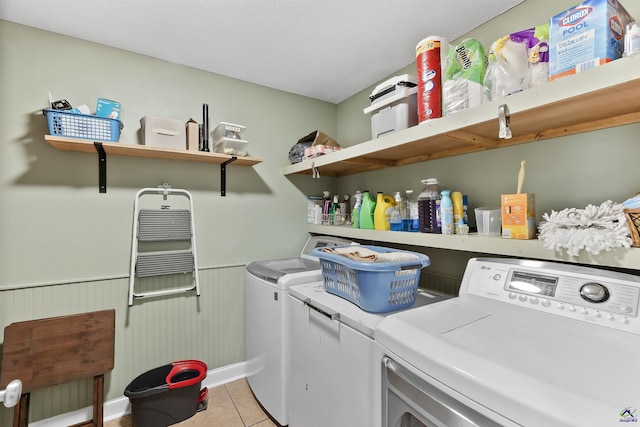 2725 Moseley Rd, Byron, GA 31008 - laundry area with washer and dryer, light tile patterned flooring, a wainscoted wall, and baseboards