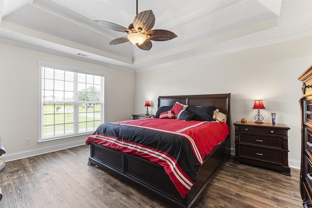 2725 Moseley Rd, Byron, GA 31008 - bedroom featuring a tray ceiling, dark wood-style floors, baseboards, ornamental molding, and a ceiling fan