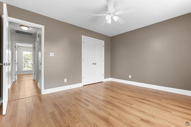 2725 Moseley Rd, Byron, GA 31008 - unfurnished bedroom featuring light wood-style flooring, baseboards, a closet, and ceiling fan
