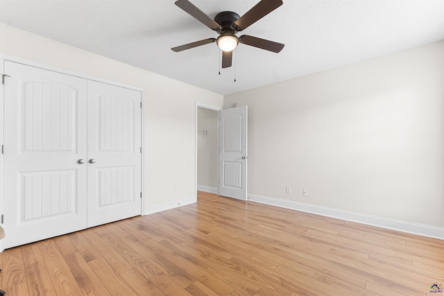 2725 Moseley Rd, Byron, GA 31008 - unfurnished bedroom featuring light wood-style flooring, baseboards, a closet, and a ceiling fan