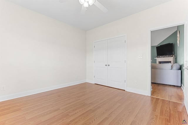 2725 Moseley Rd, Byron, GA 31008 - unfurnished bedroom with light wood-style floors, a closet, baseboards, and ceiling fan