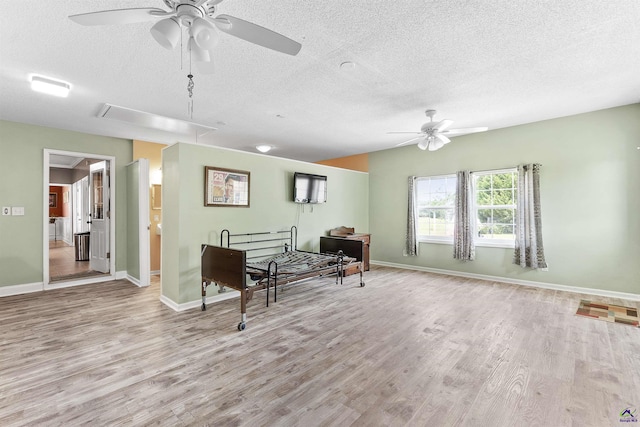 2725 Moseley Rd, Byron, GA 31008 - sitting room with ceiling fan, a textured ceiling, wood finished floors, attic access, and baseboards