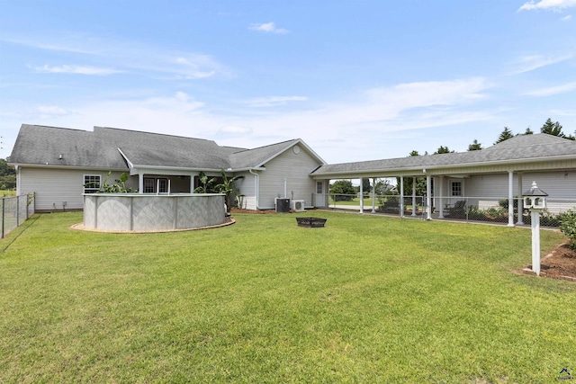 2725 Moseley Rd, Byron, GA 31008 - rear view of property with an outdoor pool and a fire pit