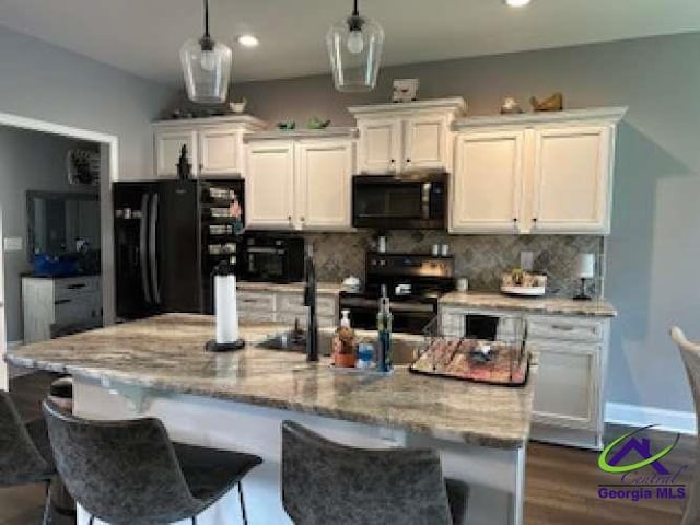 403 Hunts Landing Dr, Kathleen, GA 31047 - kitchen with freestanding refrigerator, range, white cabinetry, decorative backsplash, and recessed lighting