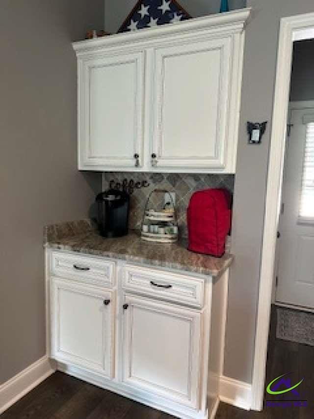 403 Hunts Landing Dr, Kathleen, GA 31047 - bar featuring baseboards and dark wood-type flooring