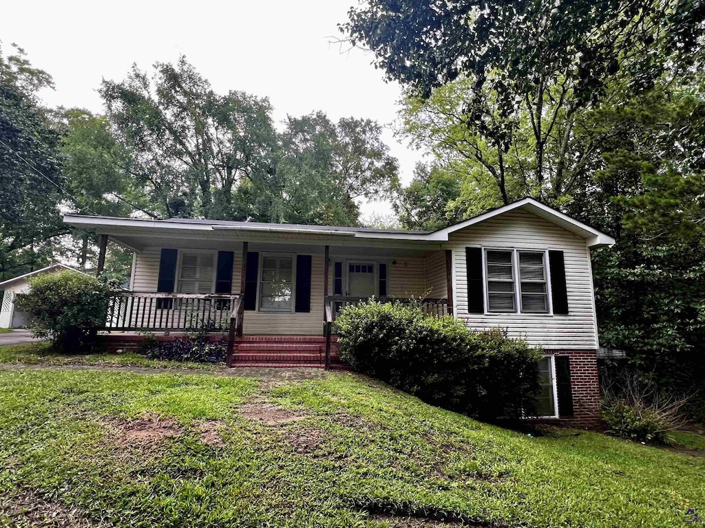 5115 Wesleyan Cir, Macon, GA 31210 - view of front of property with a porch, a front lawn, and a garage