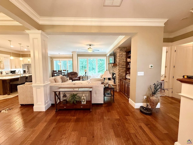 183 Terrell Rd, Elko, GA 31025 - living room featuring ornate columns, crown molding, a ceiling fan, dark wood-style floors, and baseboards