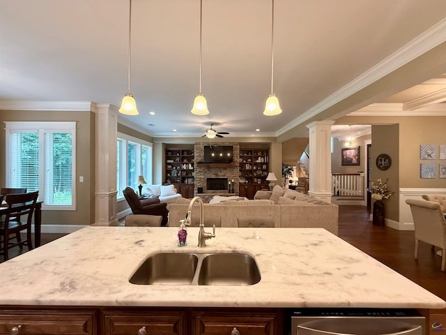 183 Terrell Rd, Elko, GA 31025 - kitchen featuring a sink, decorative columns, a stone fireplace, ornamental molding, and light stone countertops