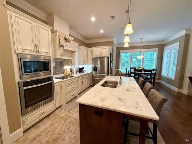 183 Terrell Rd, Elko, GA 31025 - kitchen with stainless steel appliances, a sink, a breakfast bar, tasteful backsplash, and an island with sink