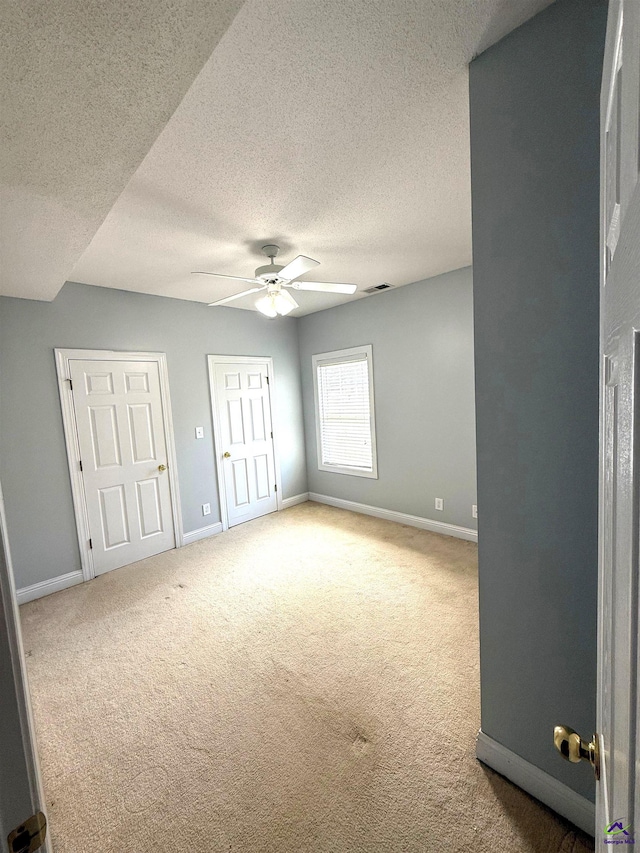426 Annies Path, Gray, GA 31032 - unfurnished bedroom featuring a textured ceiling, carpet, baseboards, and a ceiling fan