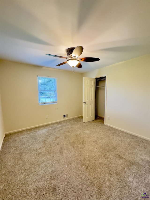221 Fox Hound Dr, Byron, GA 31008 - unfurnished bedroom featuring carpet, baseboards, a closet, and a ceiling fan