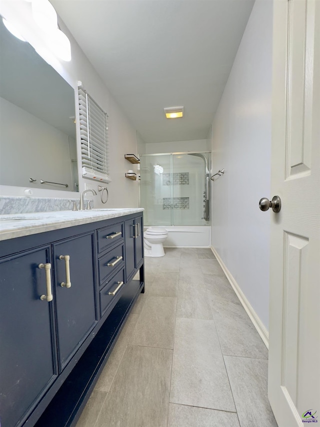 221 Fox Hound Dr, Byron, GA 31008 - full bathroom with double vanity, shower / bath combination with glass door, toilet, tile patterned floors, and baseboards