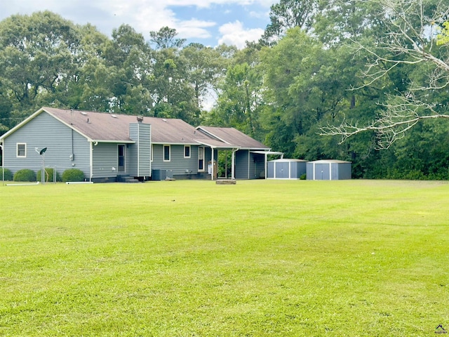 221 Fox Hound Dr, Byron, GA 31008 - view of grassy yard with central AC unit and view of wooded area