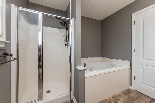 101 Barley Pl, Warner Robins, GA 31088 - full bath with a stall shower, wood finished floors, a bath, and a textured ceiling