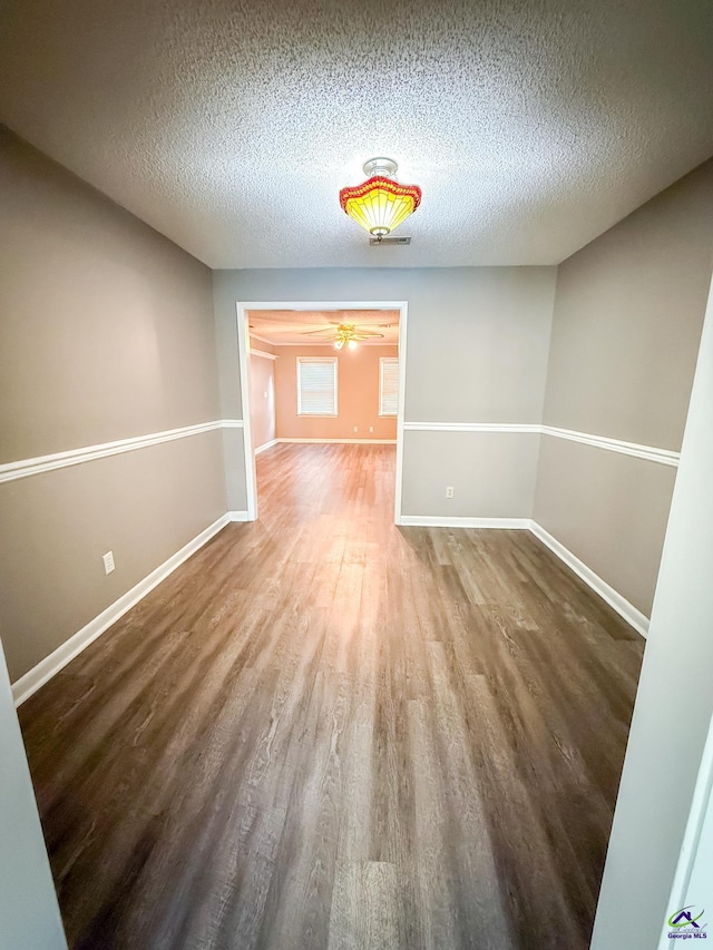 424 Wexford Cir, Bonaire, GA 31005 - unfurnished room with wood finished floors, a textured ceiling, baseboards, and ceiling fan