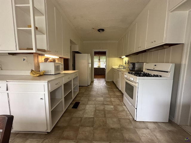 621 Forest Hill Rd, Macon, GA 31220 - kitchen featuring white appliances, white cabinets, light countertops, open shelves, and stone finish flooring