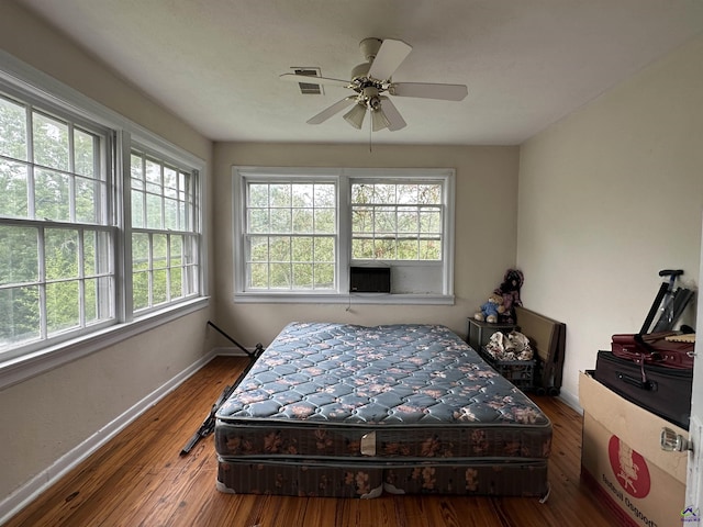 621 Forest Hill Rd, Macon, GA 31220 - bedroom with multiple windows, baseboards, hardwood / wood-style flooring, and ceiling fan