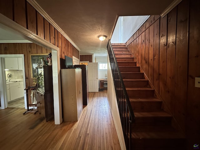 621 Forest Hill Rd, Macon, GA 31220 - staircase with wood finished floors, crown molding, wood walls, and a textured ceiling