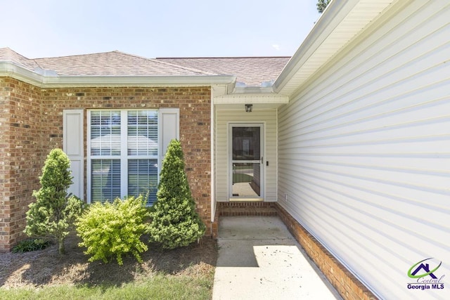 113 Castle Pines Dr, Bonaire, GA 31008 - doorway to property featuring brick siding and a shingled roof