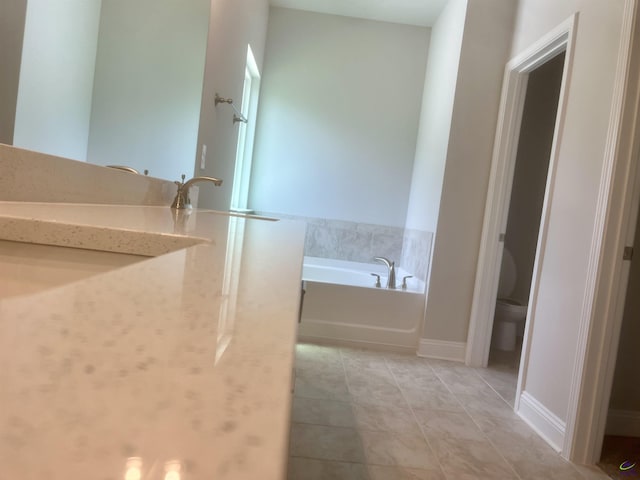 225 Shoreline Way, Macon, GA 31220 - bathroom with a garden tub, toilet, a sink, and tile patterned flooring
