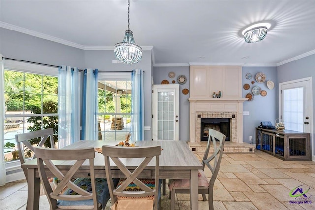 117 Richfield Cir, Kathleen, GA 31047 - dining area featuring stone tile flooring, a chandelier, a fireplace, and ornamental molding