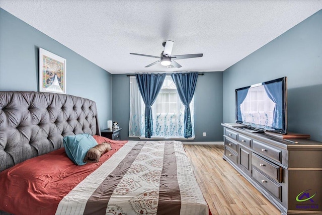 117 Richfield Cir, Kathleen, GA 31047 - bedroom with light wood finished floors, a textured ceiling, baseboards, and a ceiling fan