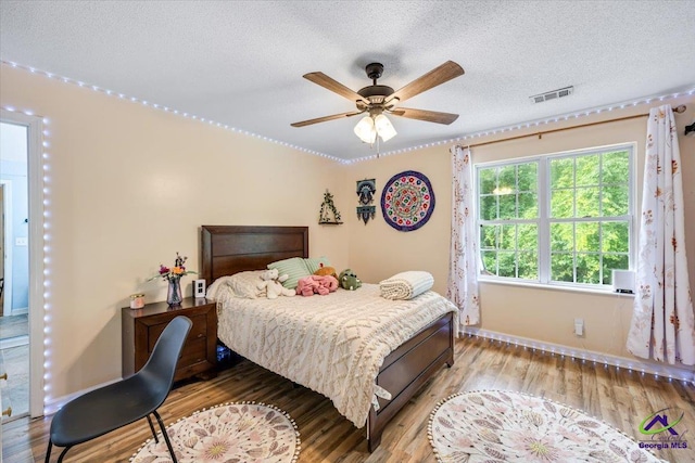 117 Richfield Cir, Kathleen, GA 31047 - bedroom featuring light wood finished floors, baseboards, a textured ceiling, and ceiling fan
