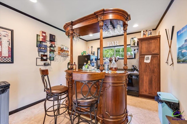117 Richfield Cir, Kathleen, GA 31047 - indoor dry bar featuring crown molding, freestanding refrigerator, light tile patterned floors, recessed lighting, and baseboards