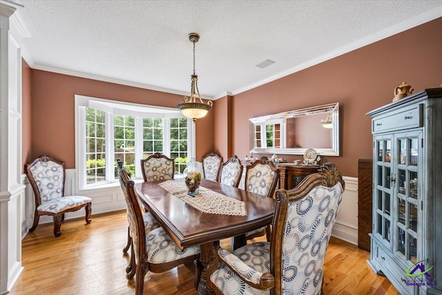 117 Richfield Cir, Kathleen, GA 31047 - dining area featuring a textured ceiling, light wood-type flooring, crown molding, and a wainscoted wall