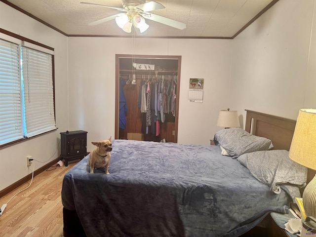 2204 Sheppard Rd, Cordele, GA 31015 - bedroom with ornamental molding, wood finished floors, a closet, a ceiling fan, and baseboards
