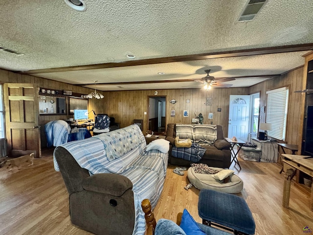 2204 Sheppard Rd, Cordele, GA 31015 - living area with wooden walls, a textured ceiling, wood finished floors, beamed ceiling, and a ceiling fan