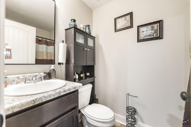 224 Allentown Ln, Macon, GA 31216 - bathroom featuring toilet, vanity, and baseboards