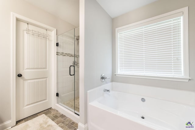 224 Allentown Ln, Macon, GA 31216 - full bathroom featuring a garden tub, a stall shower, stone finish flooring, and baseboards
