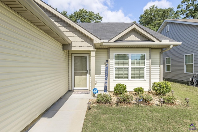 224 Allentown Ln, Macon, GA 31216 - view of exterior entry with a yard and roof with shingles