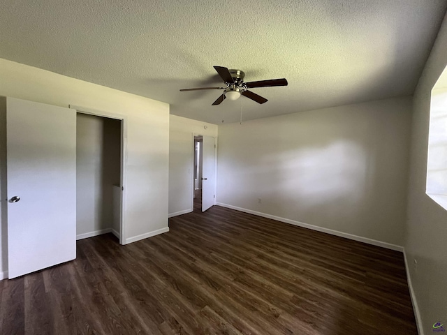 571 Duncan Ave, Unadilla, GA 31091 - unfurnished bedroom with dark wood-style flooring, baseboards, a textured ceiling, and ceiling fan