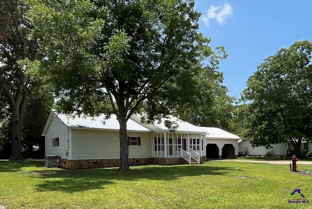 571 Duncan Ave, Unadilla, GA 31091 - back of house with a lawn, a garage, and cooling unit