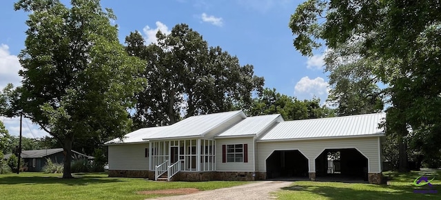 571 Duncan Ave, Unadilla, GA 31091 - view of front of house with a front lawn, dirt driveway, crawl space, metal roof, and an attached garage