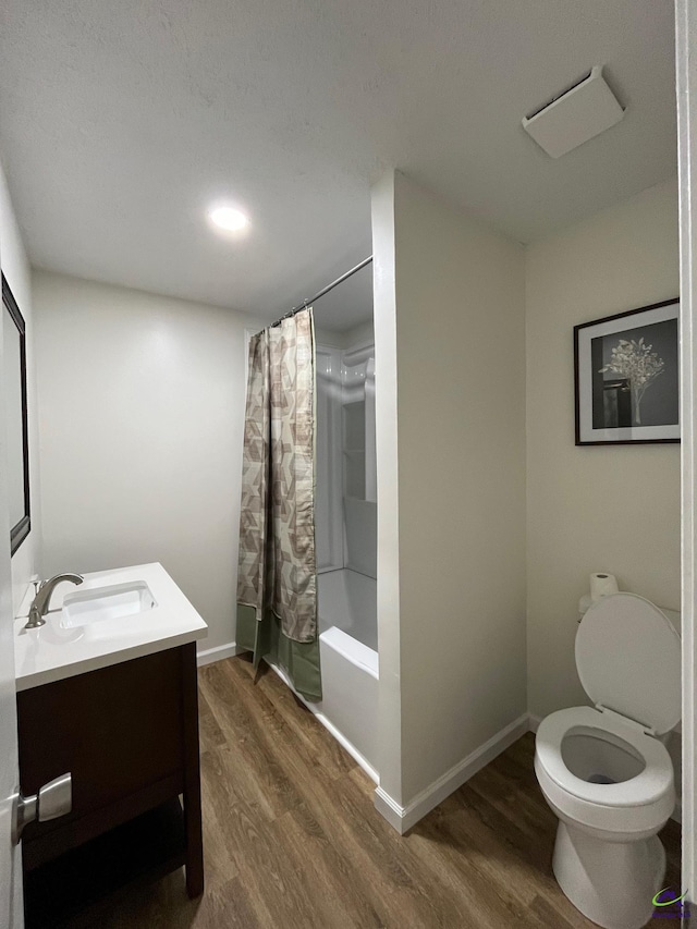 571 Duncan Ave, Unadilla, GA 31091 - bathroom with vanity, wood finished floors, shower / tub combo, toilet, and baseboards