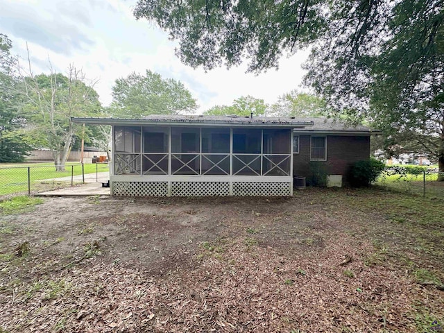 901 Ross St, Perry, GA 31069 - rear view of house with a sunroom and central AC