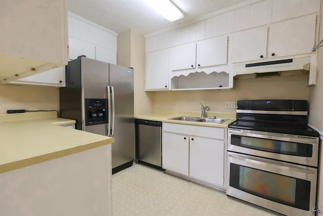 901 Ross St, Perry, GA 31069 - kitchen featuring appliances with stainless steel finishes, a sink, under cabinet range hood, light floors, and light countertops