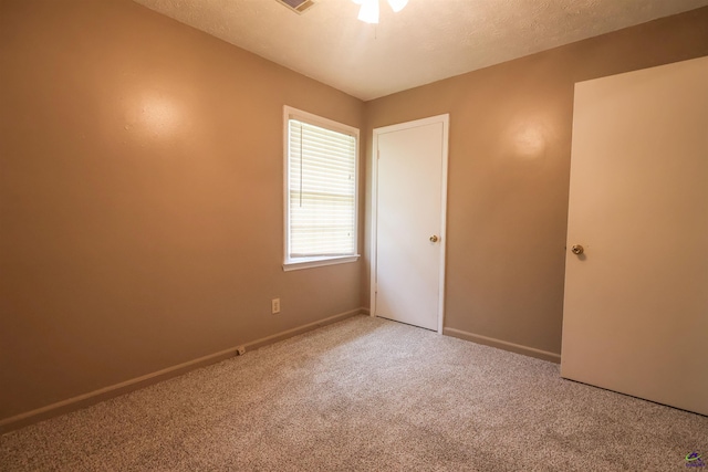 901 Ross St, Perry, GA 31069 - unfurnished bedroom with carpet, baseboards, and a textured ceiling