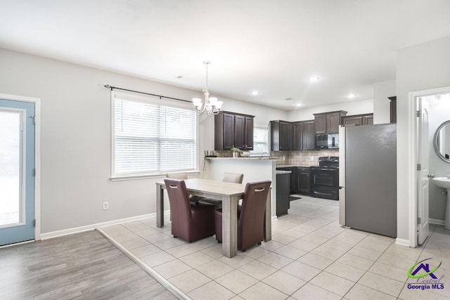 318 Flowing Meadows Dr, Bonaire, GA 31047 - dining space with a chandelier, baseboards, and recessed lighting