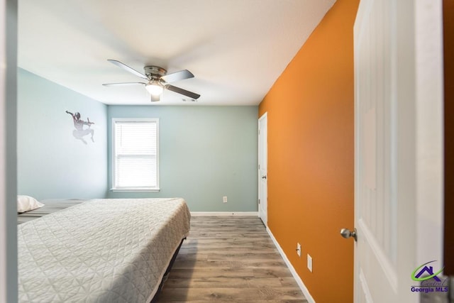 318 Flowing Meadows Dr, Bonaire, GA 31047 - bedroom featuring wood finished floors, ceiling fan, and baseboards