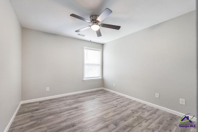 318 Flowing Meadows Dr, Bonaire, GA 31047 - spare room with wood finished floors, ceiling fan, and baseboards
