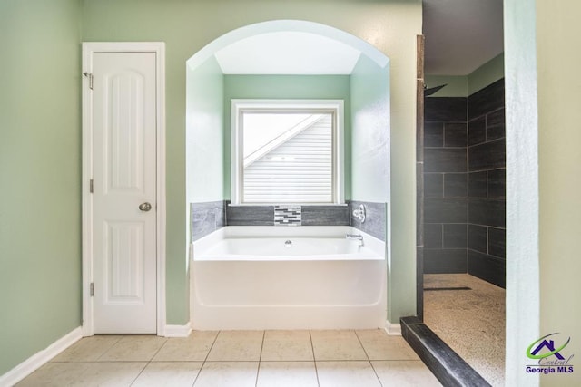 318 Flowing Meadows Dr, Bonaire, GA 31047 - bathroom featuring a bath, a tile shower, and tile patterned floors