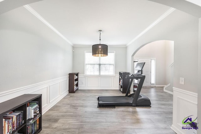 318 Flowing Meadows Dr, Bonaire, GA 31047 - exercise room featuring arched walkways, a decorative wall, crown molding, a wainscoted wall, and wood finished floors