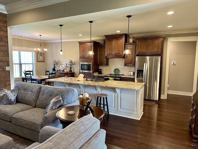 204 Bobtail Run, Kathleen, GA 31047 - kitchen featuring stainless steel appliances, ornamental molding, a breakfast bar area, recessed lighting, and a chandelier
