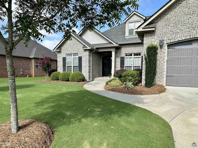204 Bobtail Run, Kathleen, GA 31047 - view of front of home featuring brick siding, a front yard, roof with shingles, and an attached garage