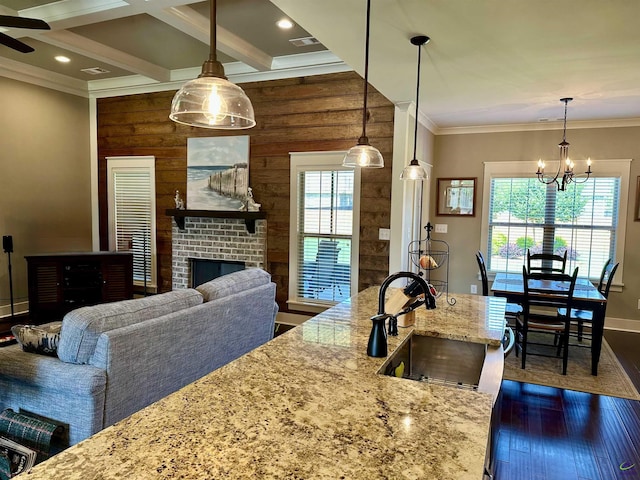 204 Bobtail Run, Kathleen, GA 31047 - kitchen featuring a sink, a chandelier, dark wood-style floors, wood walls, and baseboards